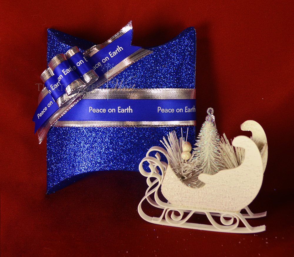 Customize your Merry Christmas ribbon with a logo or message in blue and silver for an elegant statement. Create a personalized ribbon they will want to keep as memories of a special occasion or holiday.  Add a sleigh ornament for even more fun.